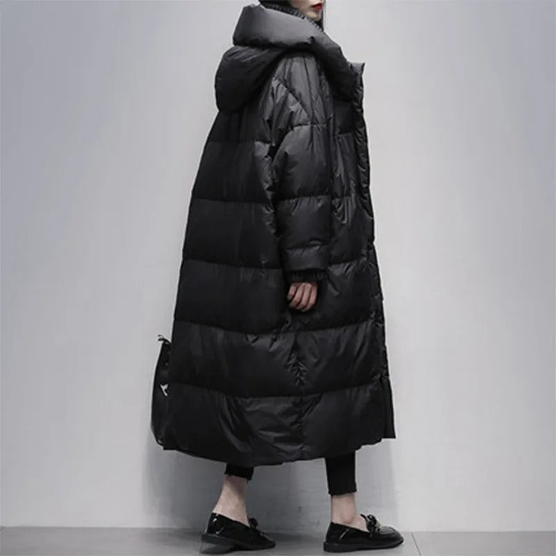 Side view of a woman in a long black quilted winter jacket