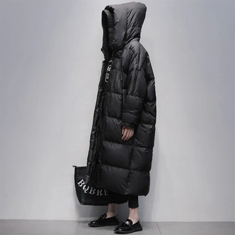 Profile view of a woman wearing a long black winter coat