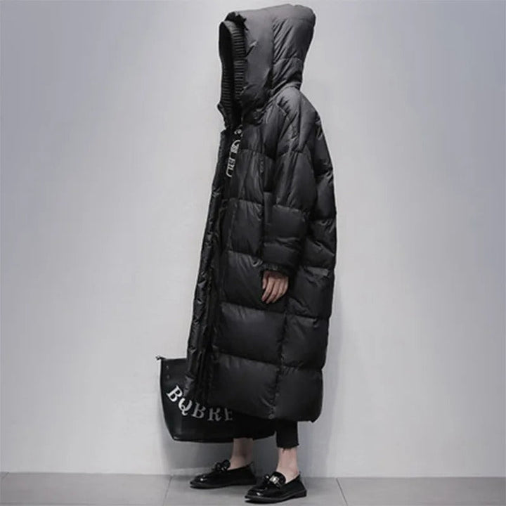 Profile view of a woman wearing a long black winter coat
