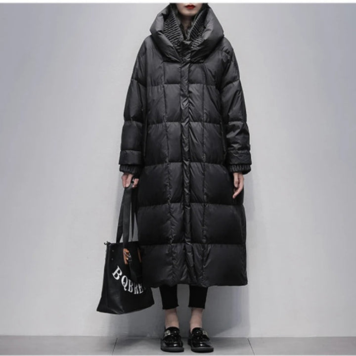 Woman wearing a long black padded winter coat with a hood