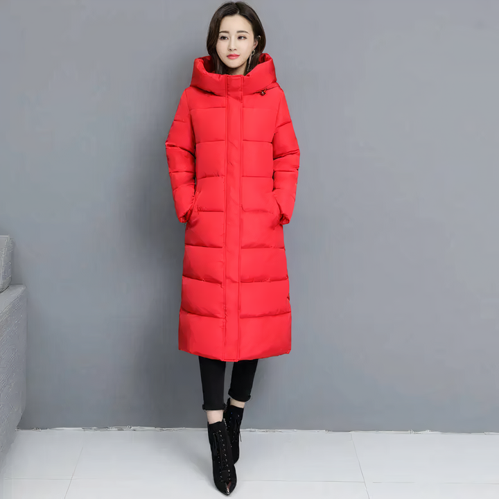 Woman wearing a bright red long puffer jacket with a hood