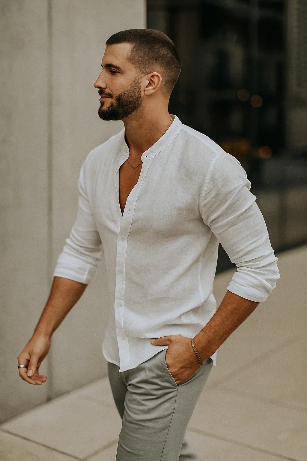 Side profile view of a man in a white band collar casual shirt