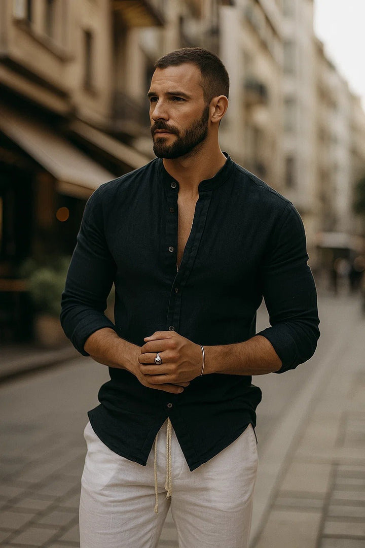Folded stack of mens long sleeve band collar shirts in solid colors