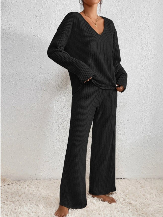 Woman wearing black ribbed loungewear set with V-neck top