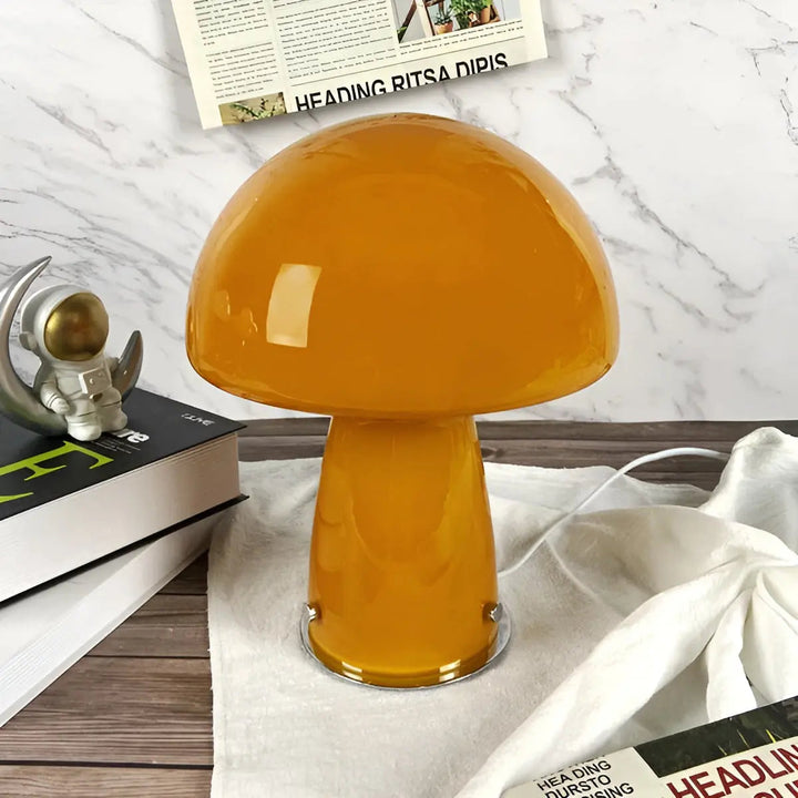 Close-up view of the orange mushroom table lamp placed on a wooden surface