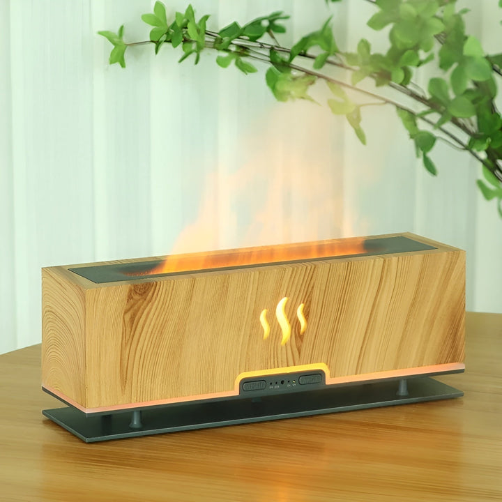 GlowFlame aroma humidifier in Light Wood Grain with yellow flame effect on wooden table