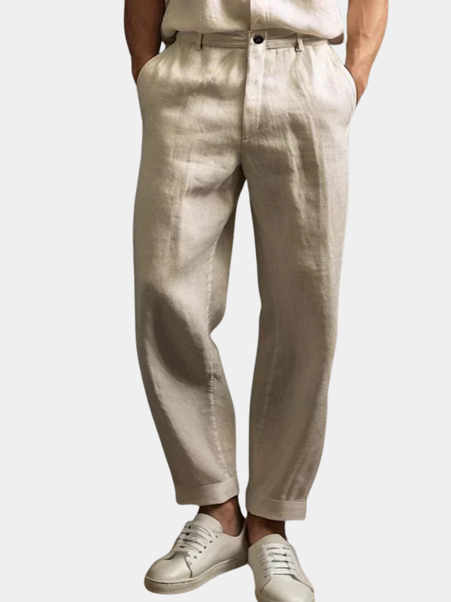 Man wearing beige relaxed drawstring pants with white sneakers