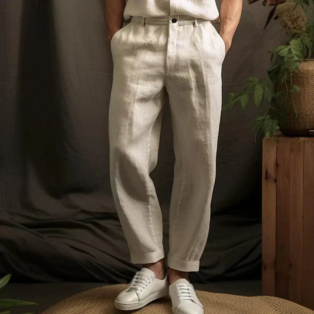 Close-up view of beige relaxed drawstring pants in a studio setting
