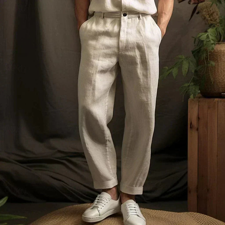 Close-up view of beige relaxed drawstring pants in a studio setting