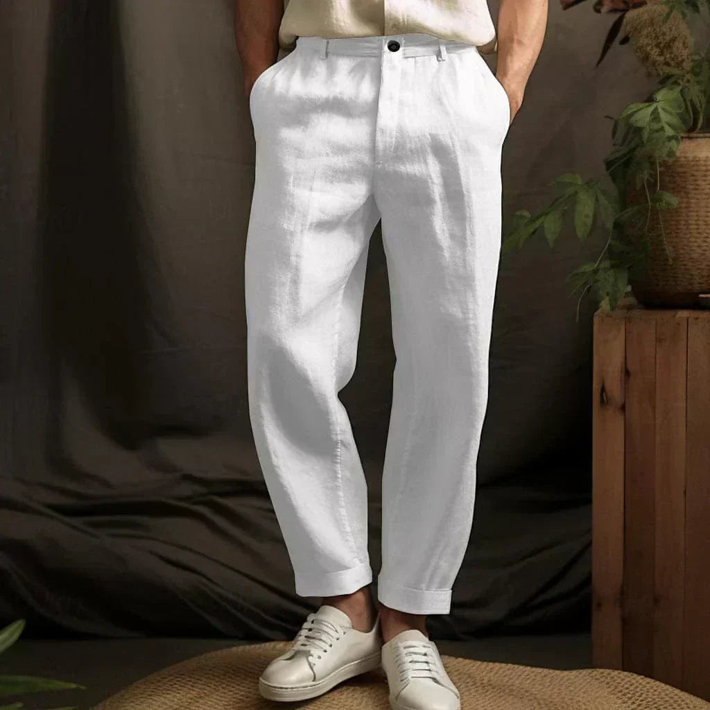 Man wearing white relaxed drawstring pants showcasing tapered ankle fit