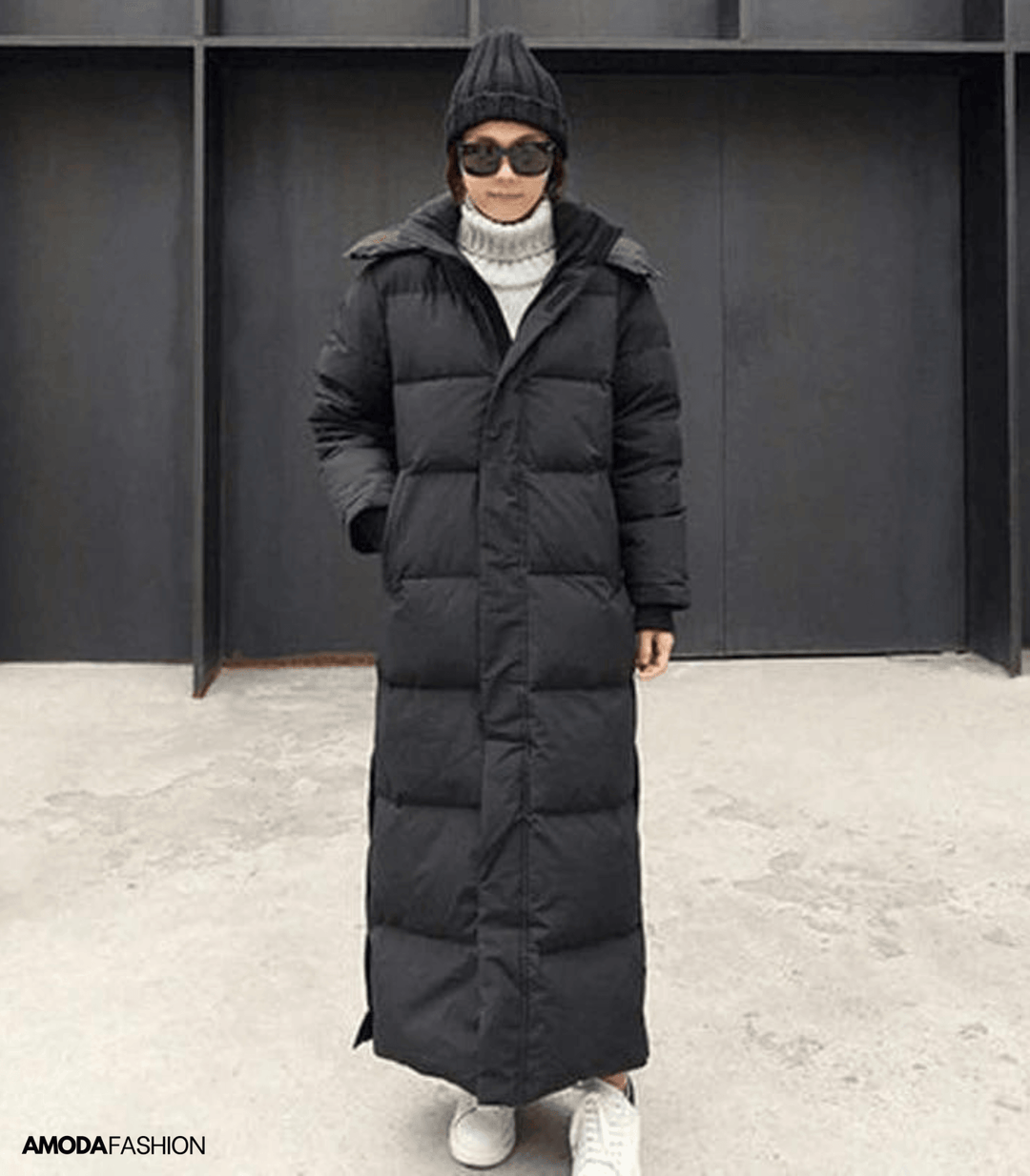 Woman wearing a black oversized long winter parka outdoors