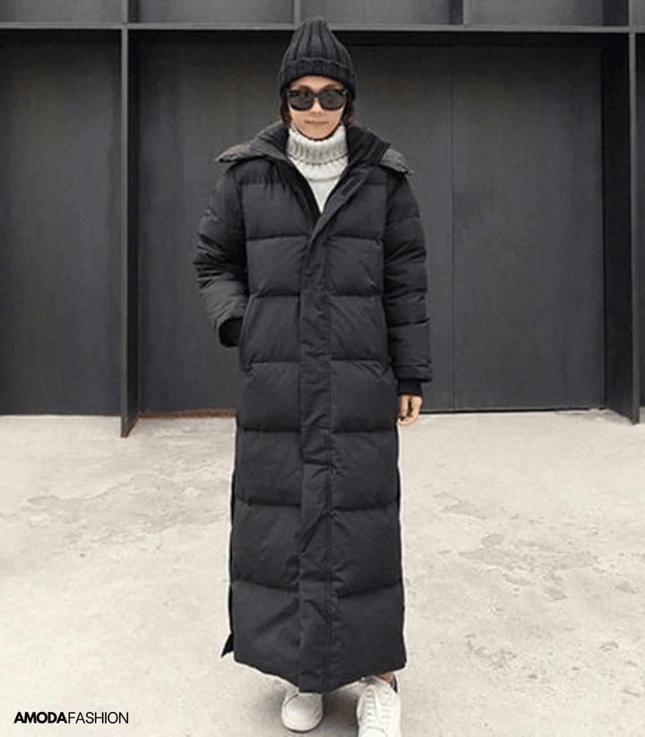 Woman wearing a black oversized long winter parka outdoors