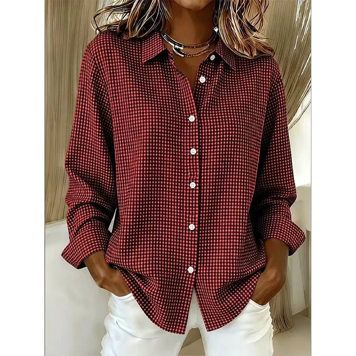 Folded stack of women's checked button-up shirts in assorted colors