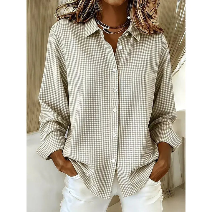 Close-up of fabric and buttons on a women's checked long sleeve top