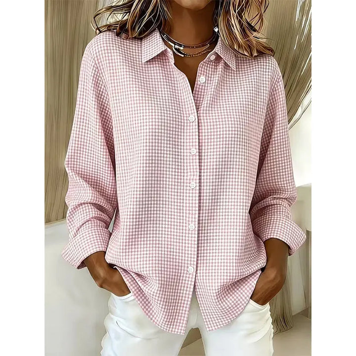 Model wearing women's gingham top tucked into high-waisted denim jeans