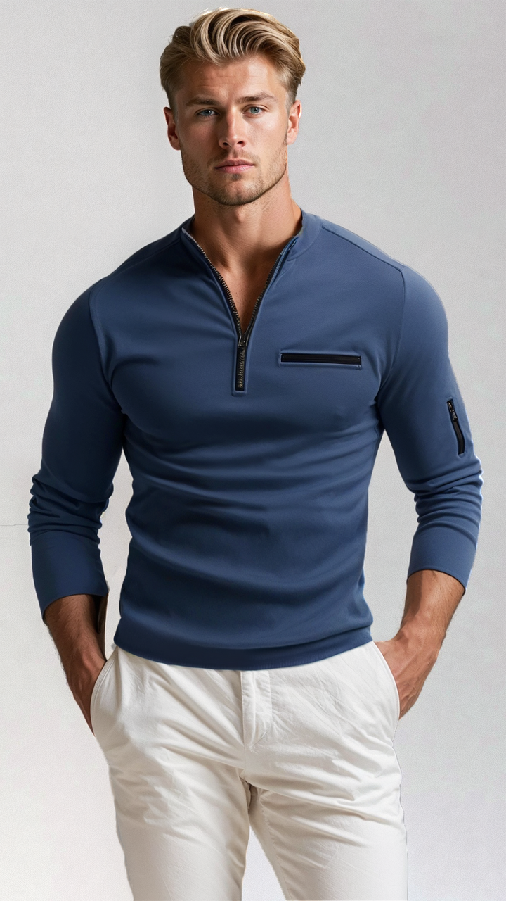 Man wearing navy blue quarter-zip sweater with white trousers