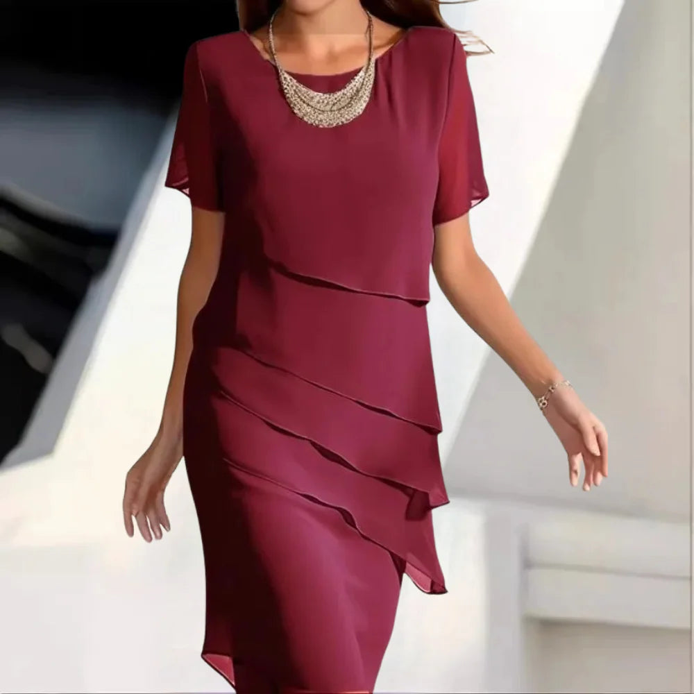 Woman wearing a burgundy red layered midi dress with short sleeves