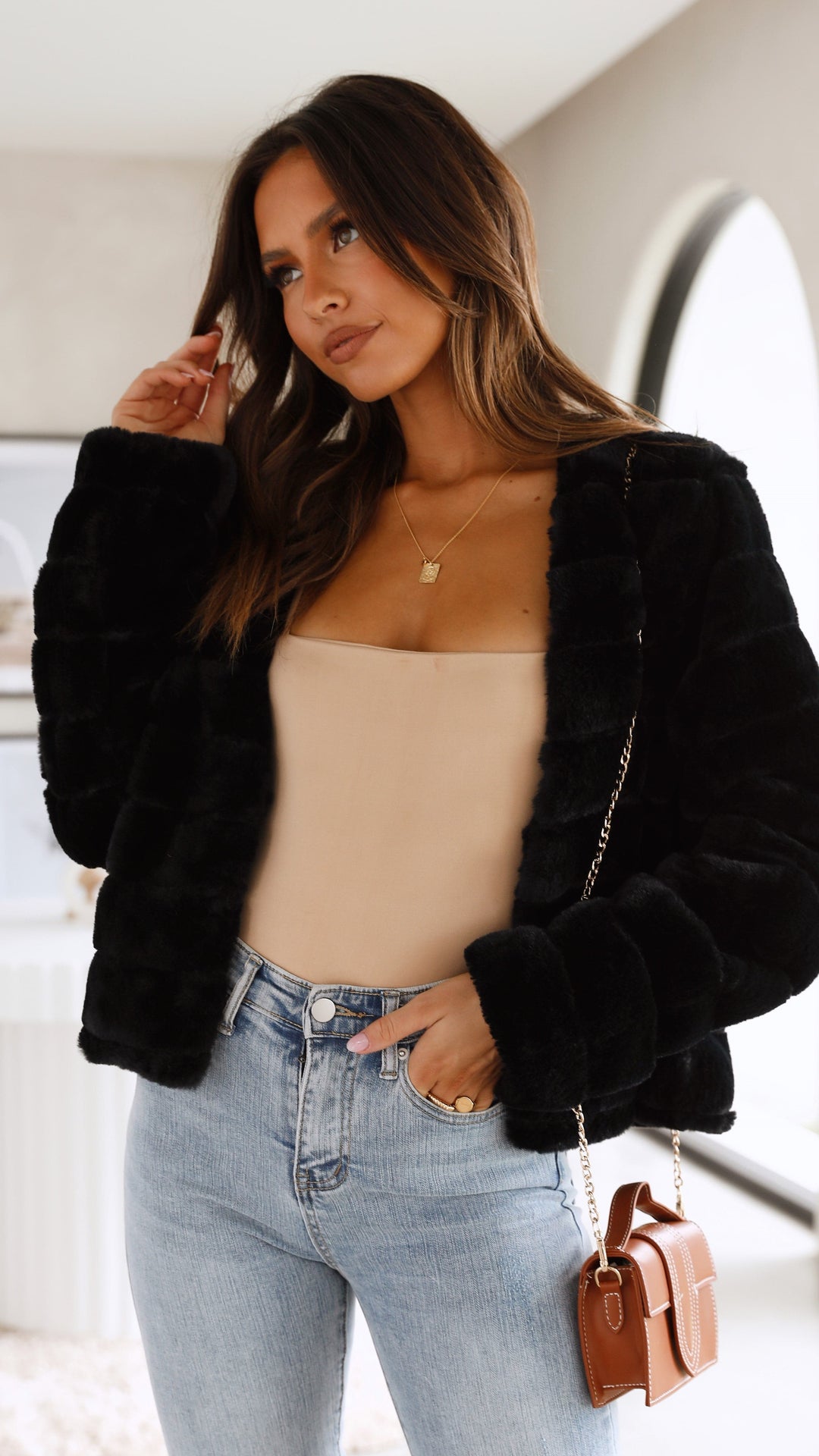 Front view of brown textured cropped jacket highlighting warm winter style