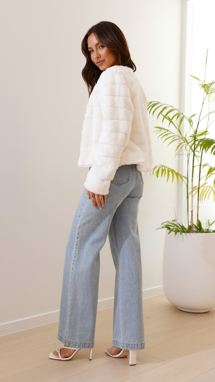Front view of black textured cropped jacket showcasing stylish cut