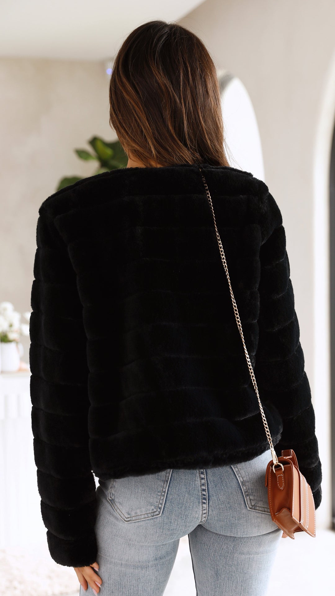 Front view of pink textured cropped jacket showing soft button closures