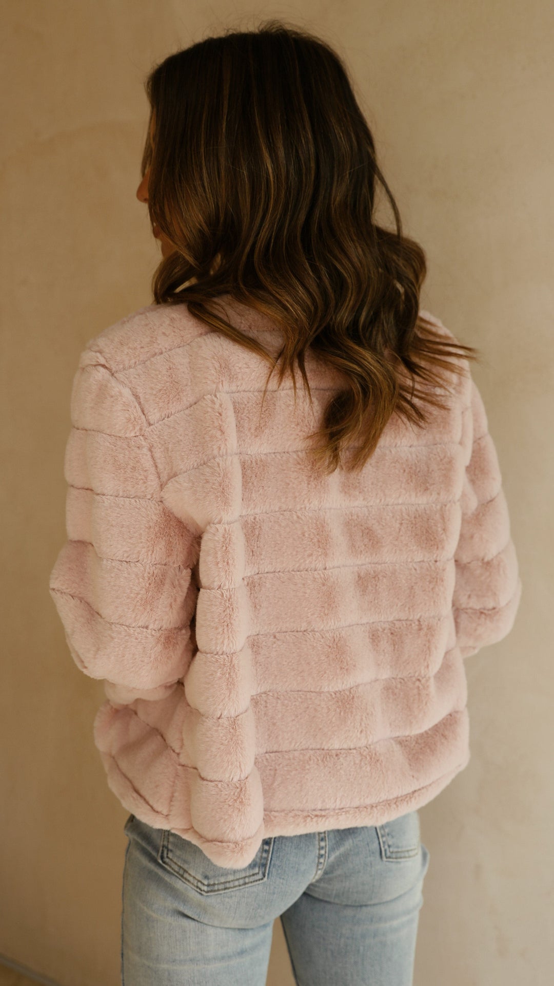 Back view of white cropped texture jacket showing clean tailored lines