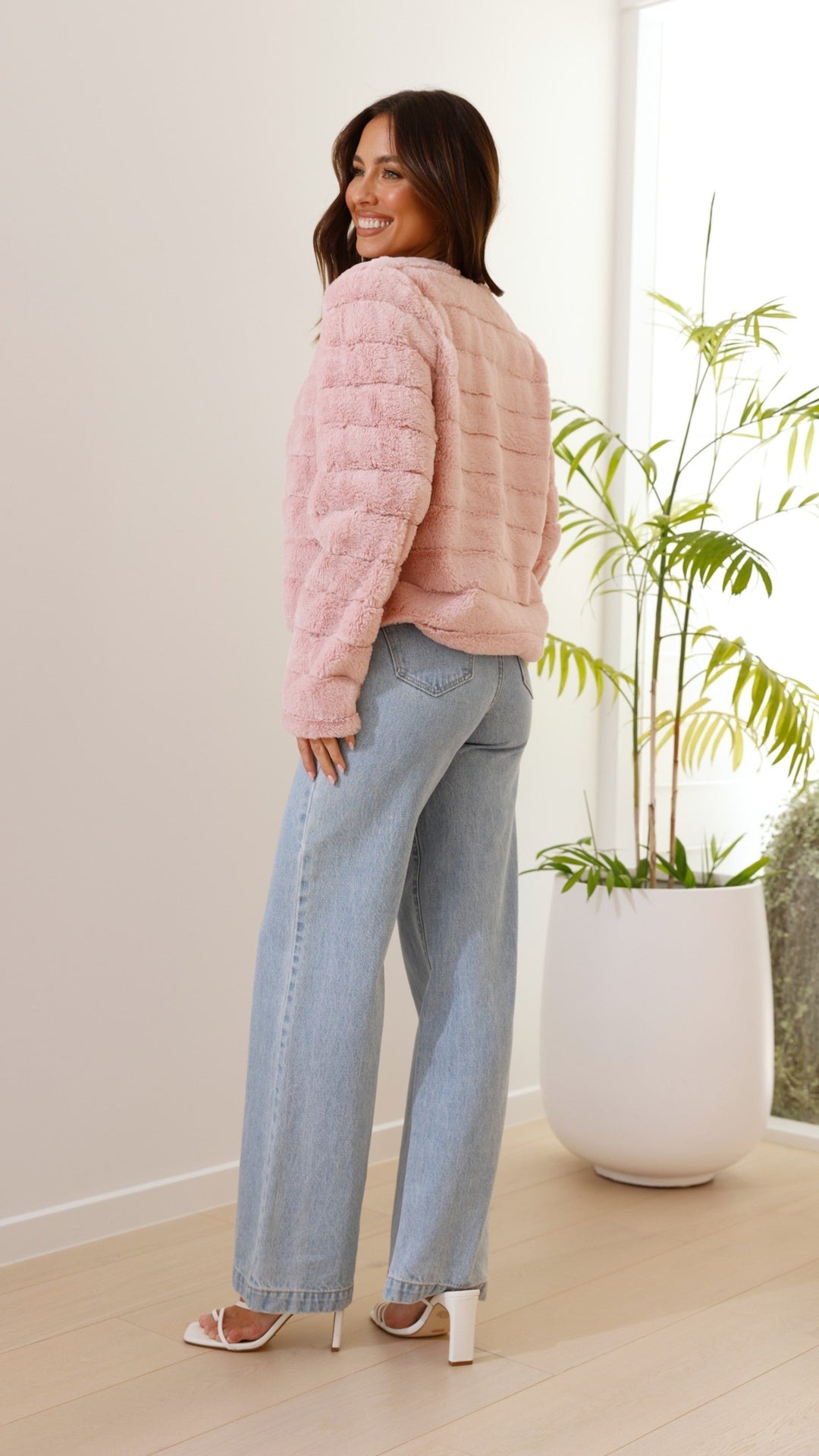 Detail shot of pink cropped jacket cuff and soft interior lining