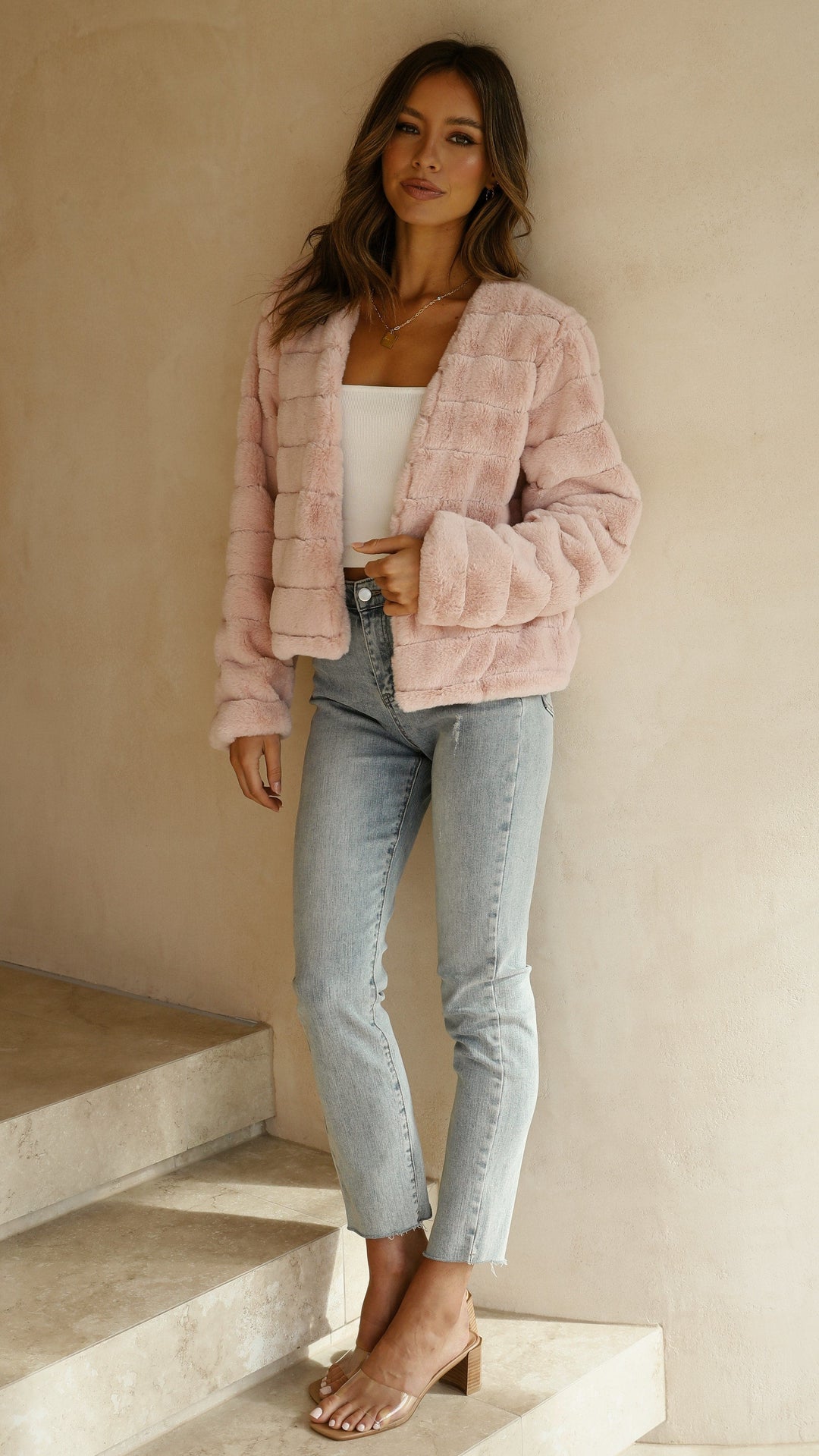 White cropped texture jacket hung neatly to display outerwear shape