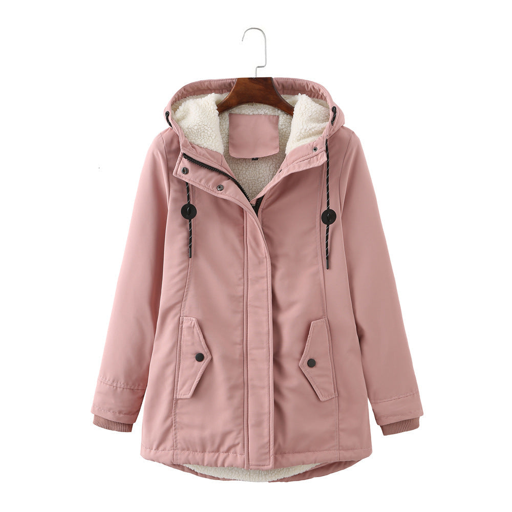 Pink women's winter parka coat hanging on a wooden hanger