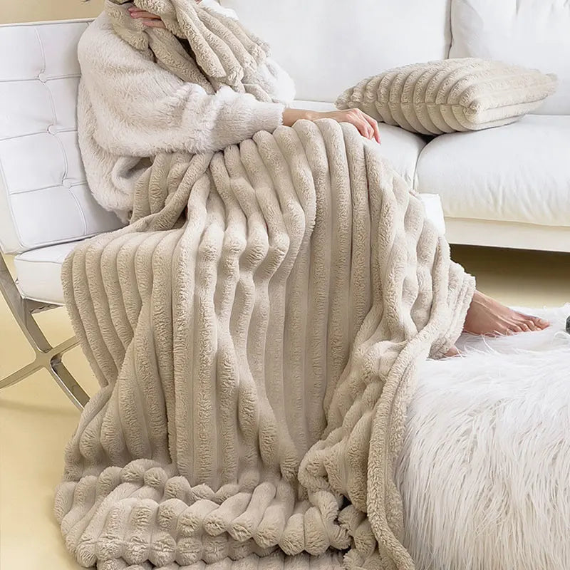 Cozy plush comfort blanket draped over a white sofa in a modern living room