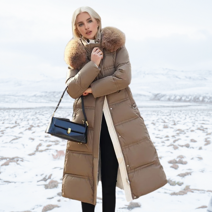 Model posing with black handbag and brown long winter coat outdoors