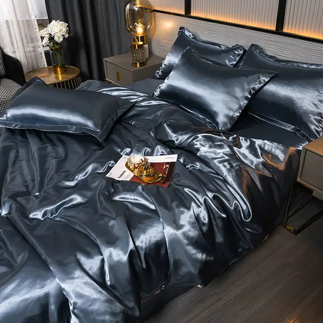 Blue grey satin duvet cover set displayed neatly on a bedroom bed