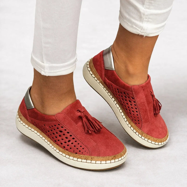Close-up of comfortable walking shoes for women featuring stylish tassel detail on top
