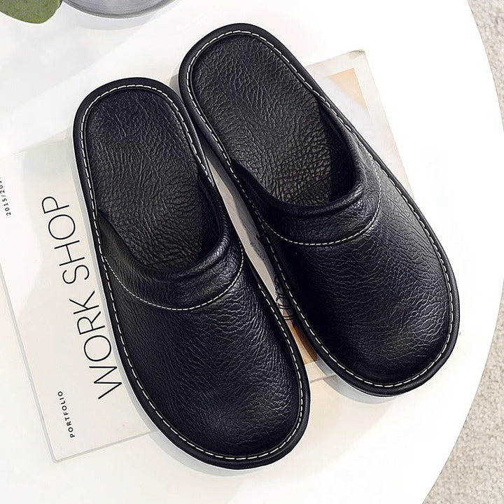 Ergonomic mens slippers showing heel support and breathable upper material