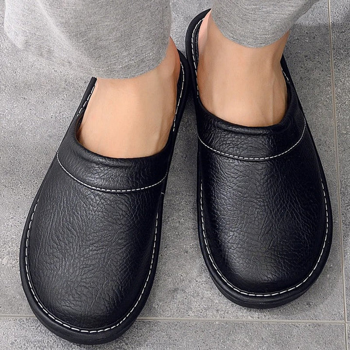 Top down view of mens comfortable home shoes with cushioned footbed