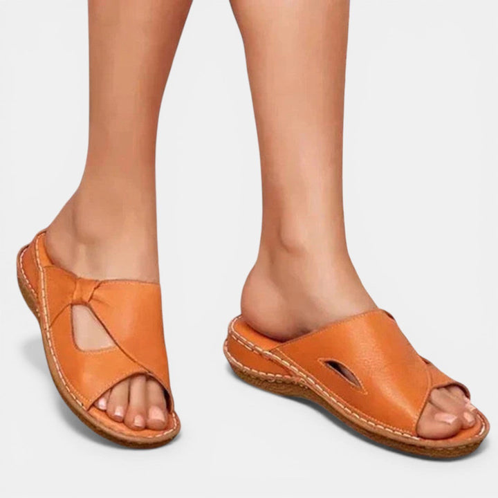 Woman wearing brown orthopaedic slip-on sandals