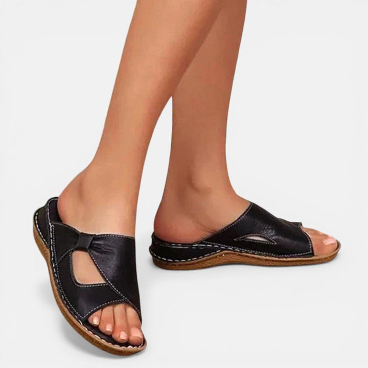 Woman wearing black orthopaedic slip-on sandals