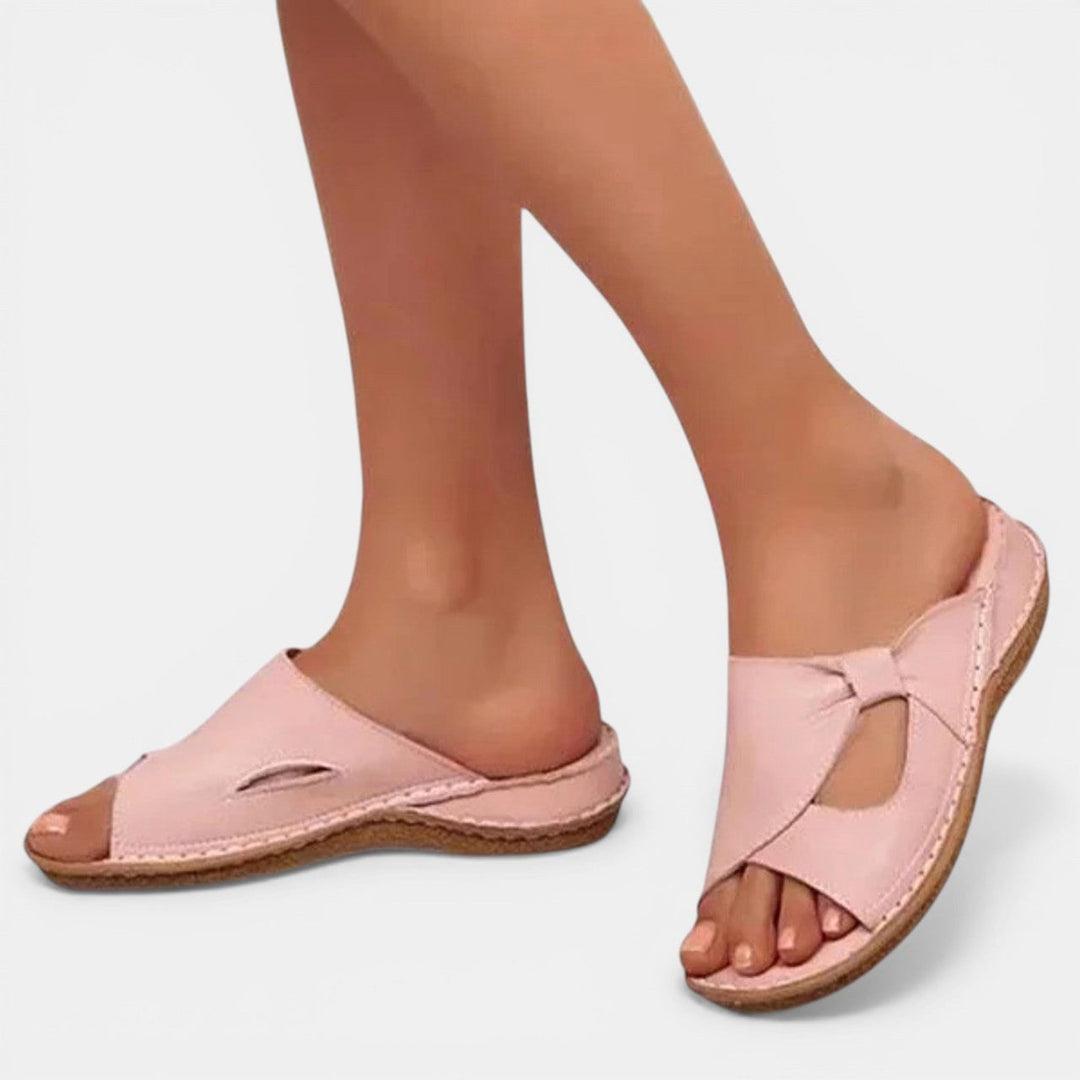 Woman wearing pink orthopaedic slip-on sandals