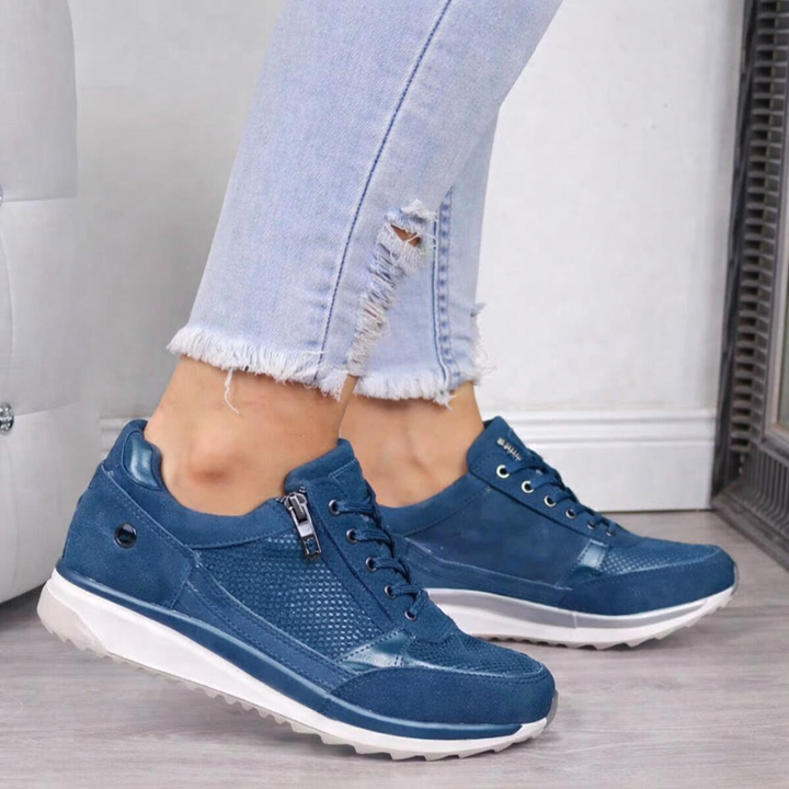 Women's studded orthopedic sneakers in black with side zip and comfortable wedge sole for casual walking.