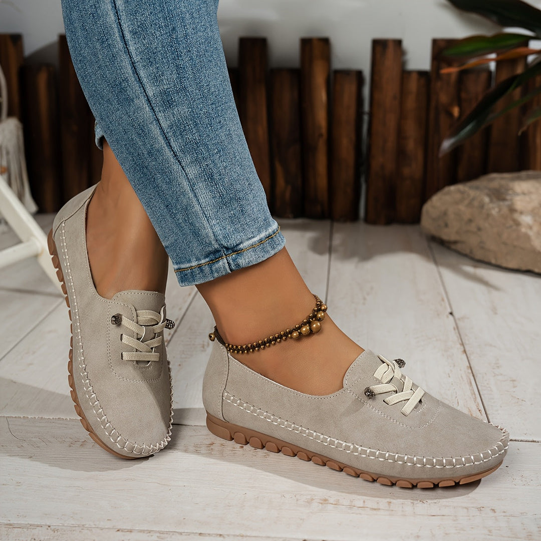 Beige casual walking shoes showcasing the soft textured finish and laces