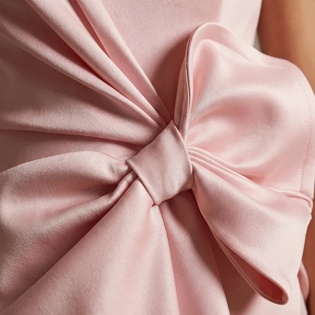 Sleeveless women's cocktail midi dress featuring elegant bow detail for formal events