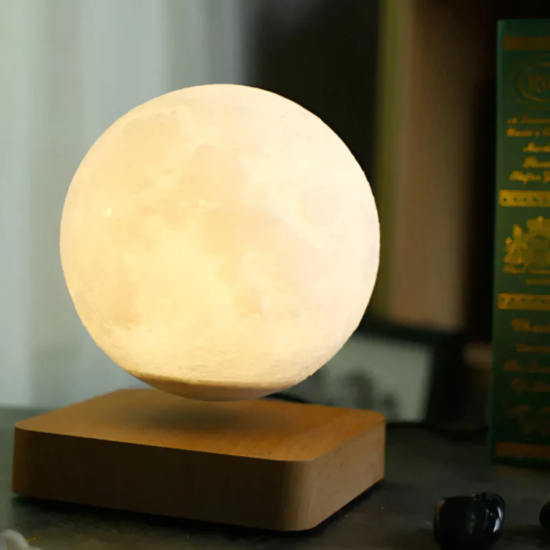 Levitating moon lamp floating in mid-air over a dark base for home decor