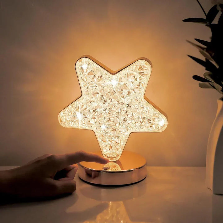 Star shaped crystal table lamp illuminating a bedside table
