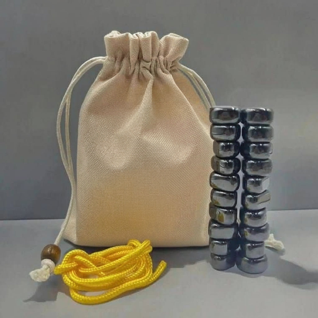 Magnetic chess game pieces stacked beside a storage pouch and yellow string