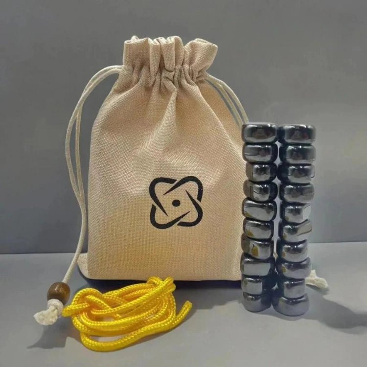Beige drawstring storage bag with black logo alongside stacked magnetic stones and a yellow cord.