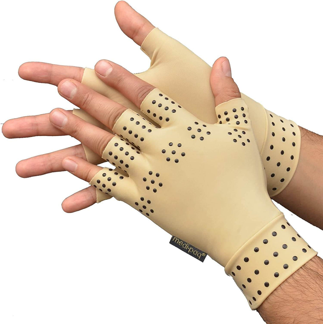 Close-up of beige fingerless compression therapy gloves with magnetic dots worn on hands.