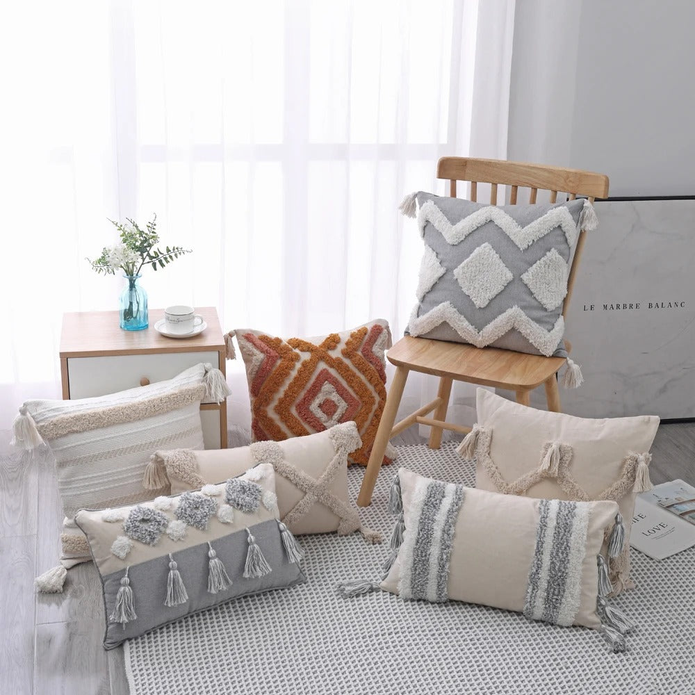 Various Moroccan style throw pillow covers displayed on a chair and floor in a modern room