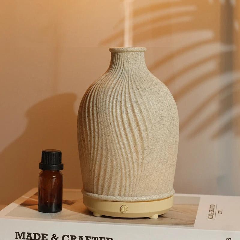 Close-up of the essential oil diffuser control buttons and mist outlet.