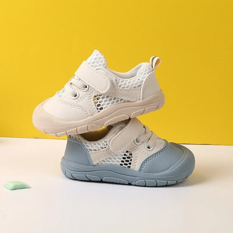 Stacked pair of children's shoes in blue and beige highlighting flexible soles.
