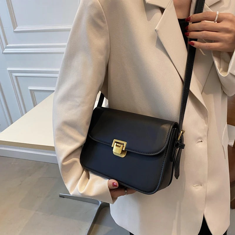Woman wearing the black Ellieza elegant shoulder bag with a blazer