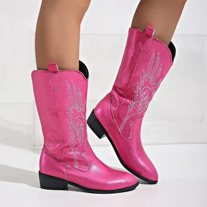 Women wearing pink western cowboy boots with intricate embroidery